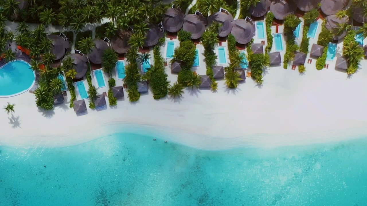 Aerial view of overwater villas and lagoon at Sun Siyam Vilu Reef, Dhaalu Atoll