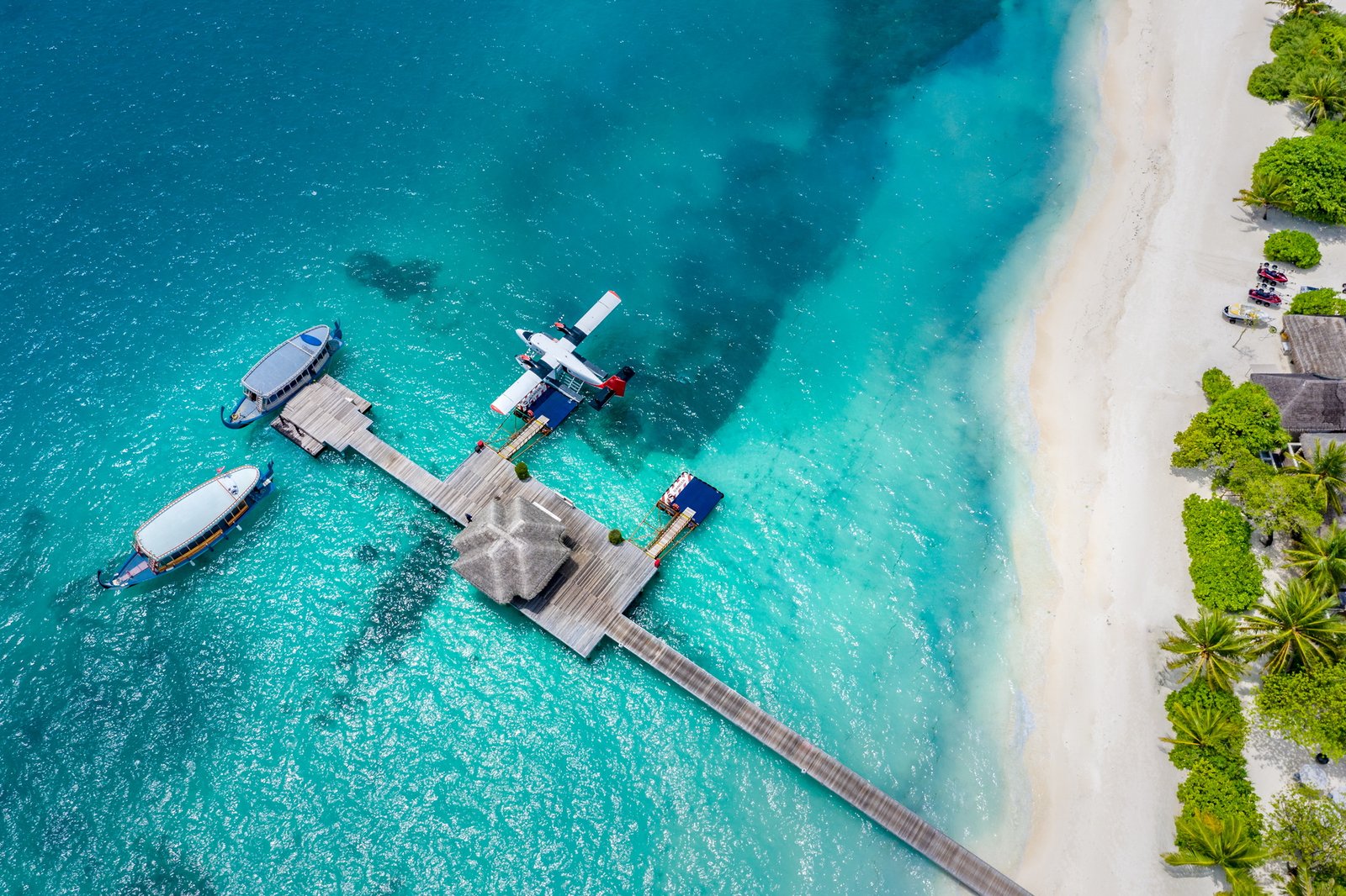 Seaplane and traditional dhoni boats at the arrival jetty, LUX* South Ari Atoll