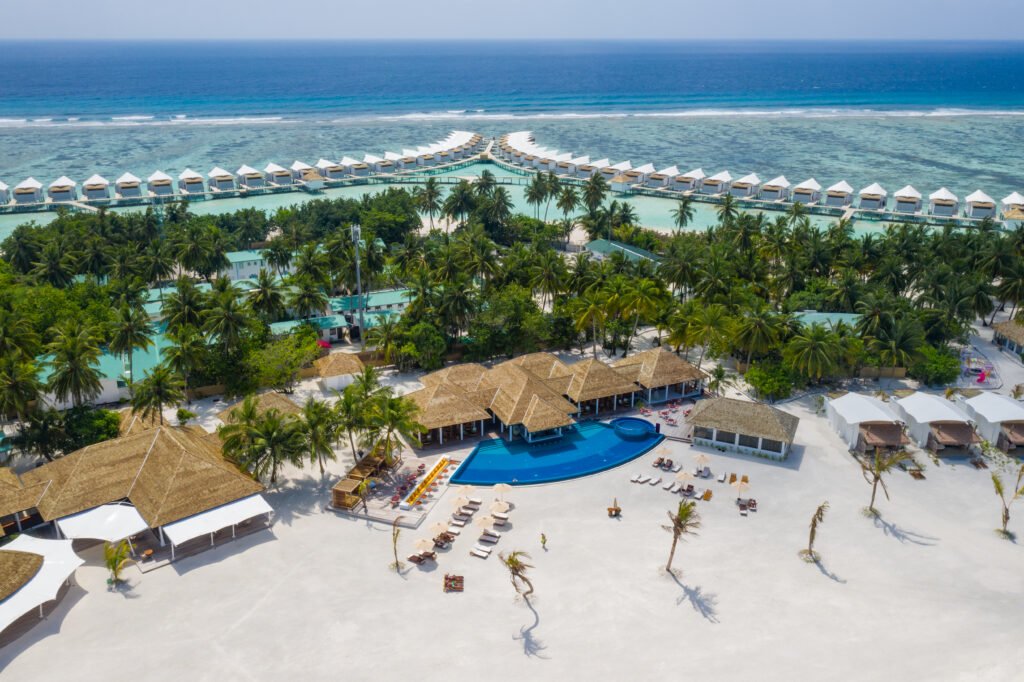 Aerial view of Cinnamon Hakuraa Huraa Maldives — overwater bungalows, pool and beach, Meemu Atoll