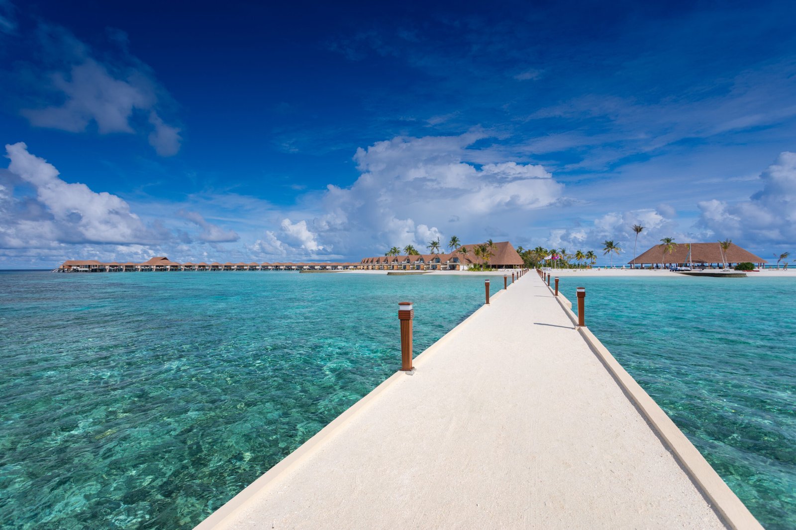 Jetty and turquoise lagoon at Cinnamon Velifushi Maldives, Vaavu Atoll