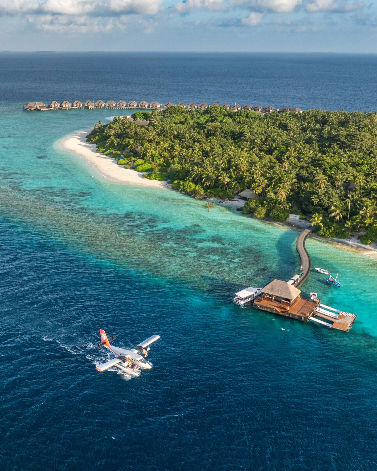 Aerial view of Dusit Thani Maldives with seaplane arriving, Baa Atoll, Maldives