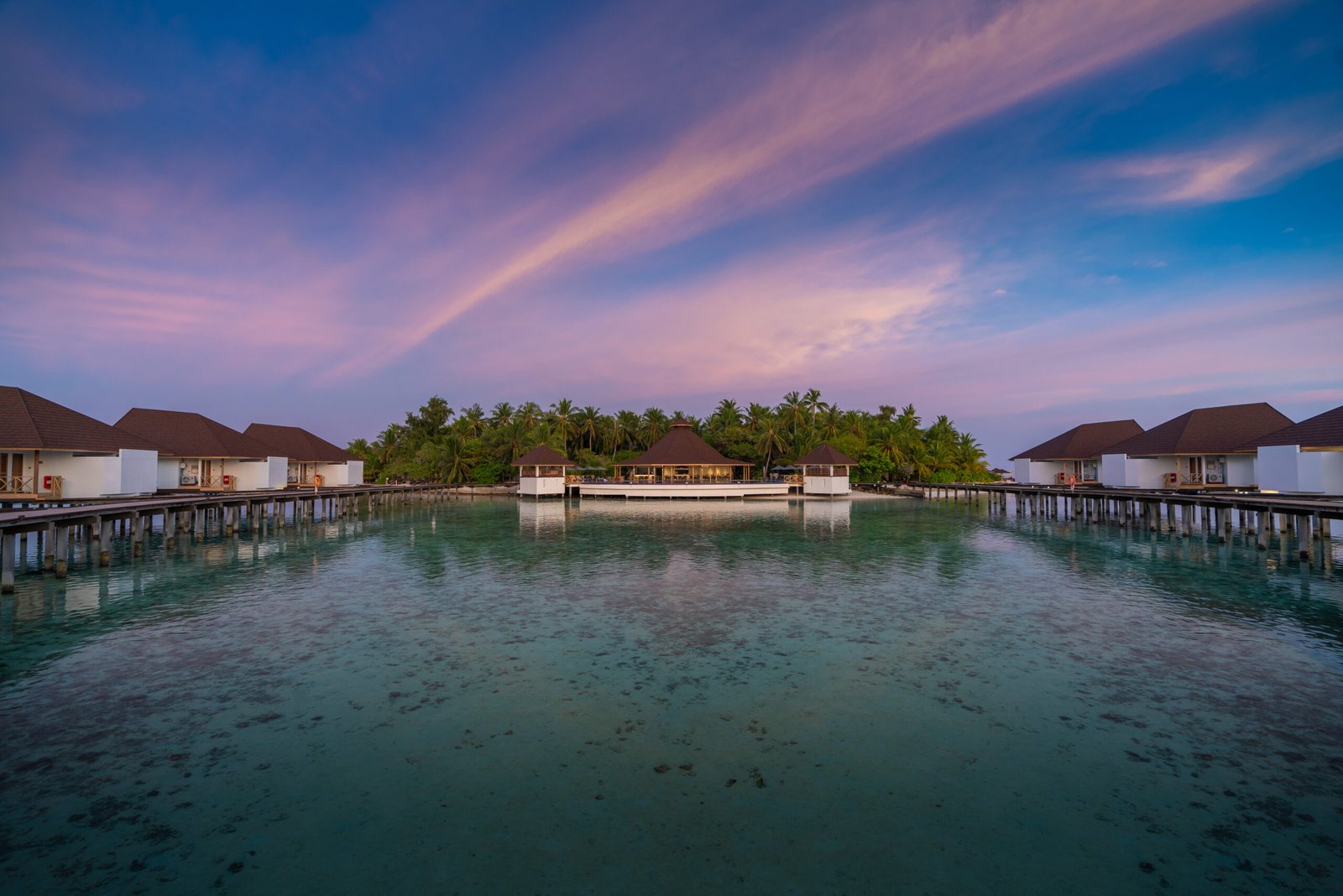 Overwater restaurant pavilion at dusk, Ellaidhoo Maldives by Cinnamon