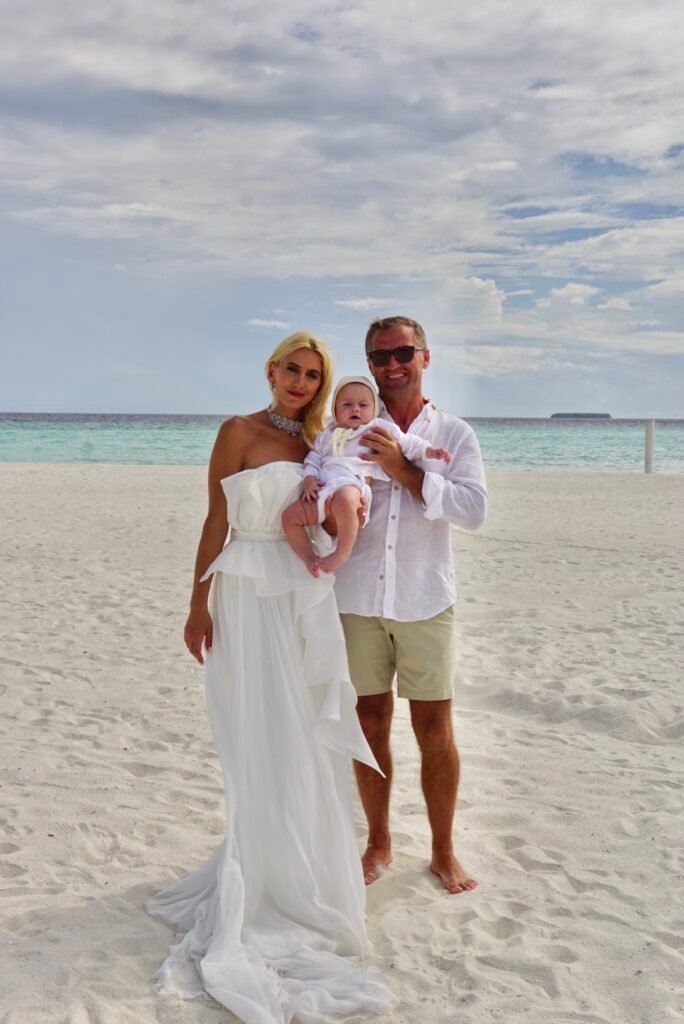 Family on the beach at Dhigufaru Island Resort