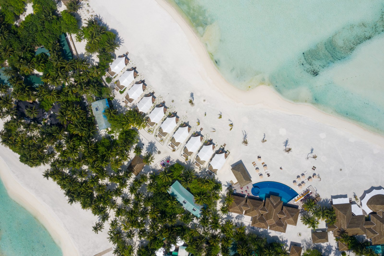 Aerial view of the Beach Bungalow row along the beach and pool deck, Cinnamon Hakuraa Huraa Maldives
