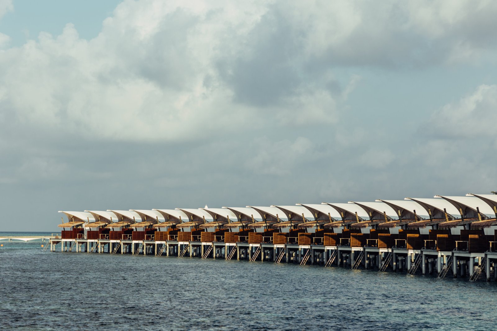 Overwater Water Bungalow row viewed from the lagoon, Cinnamon Hakuraa Huraa Maldives