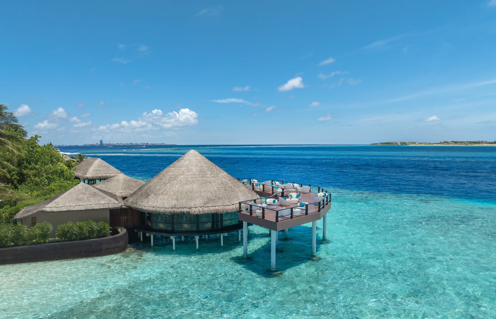 Adaaran Prestige Vadoo — Kandholi Overwater Sky Bar above the lagoon, South Malé Atoll, Maldives, with Malé visible in the distance