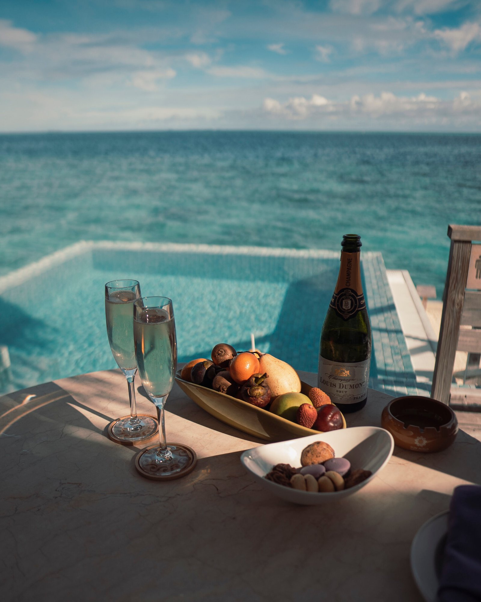 Champagne and fruit at golden hour beside a private pool, Sun Siyam Iru Veli, Maldives