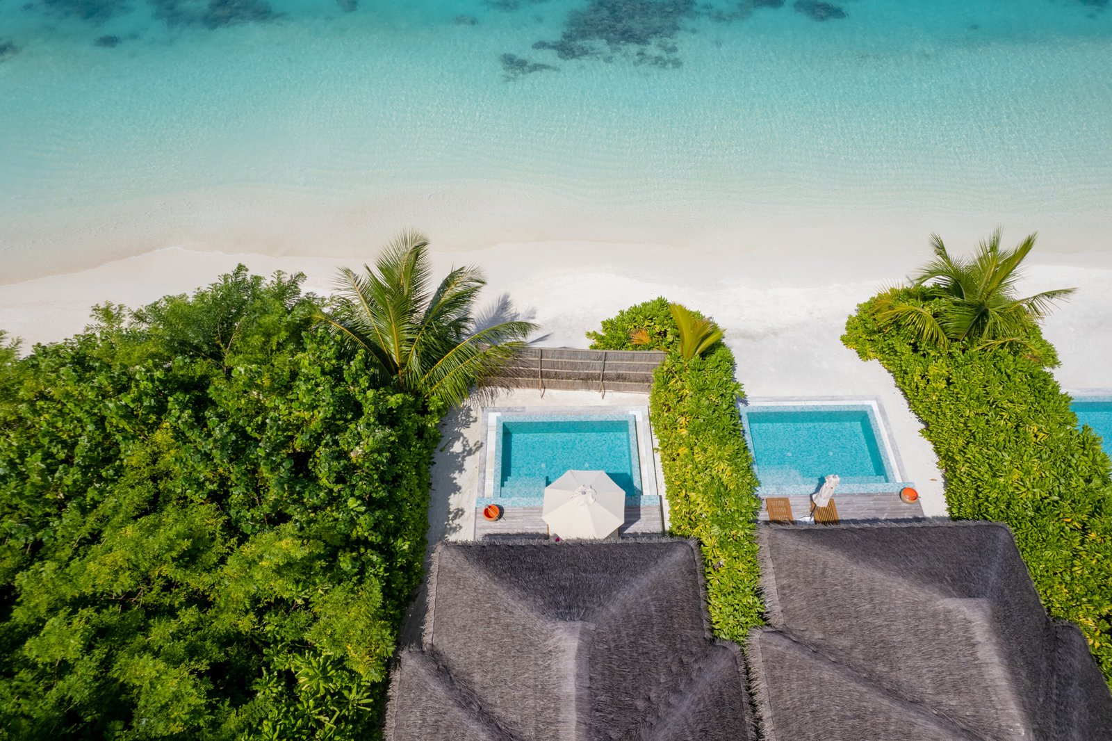 Aerial view of beachfront pool villas and white-sand beach, Sun Siyam Iru Veli, Maldives