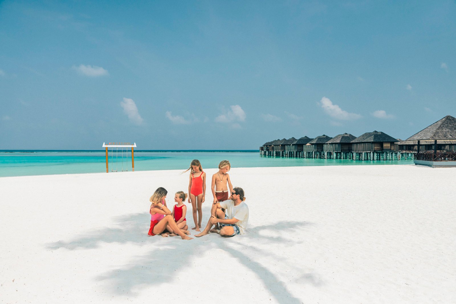 Family time on the beach at Sun Siyam Iru Fushi