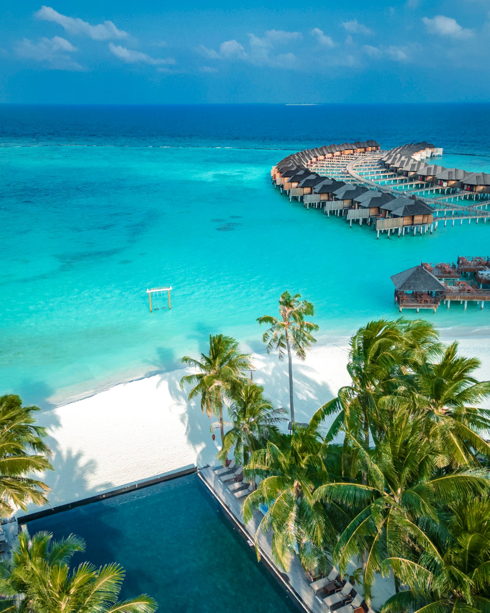 White-sand beach and infinity pool at Sun Siyam Iru Fushi, Maldives