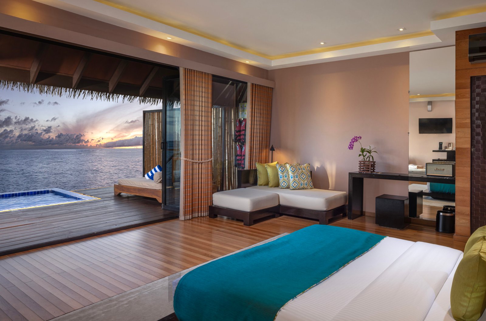 Water villa bedroom opening onto a private plunge pool and lagoon, Adaaran Prestige Vadoo