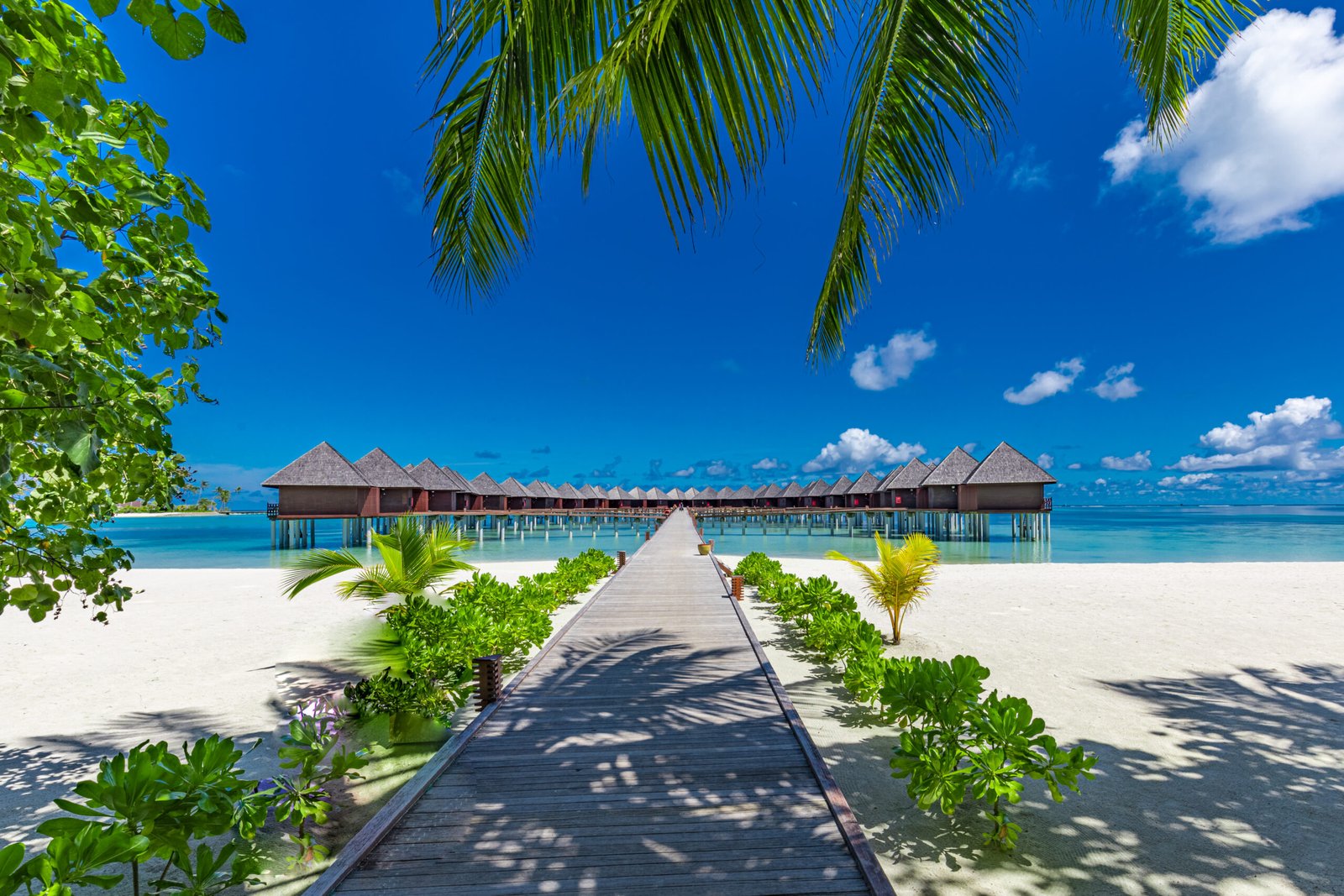 Boardwalk jetty leading to the overwater villas across the lagoon at Sun Siyam Olhuveli, Maldives