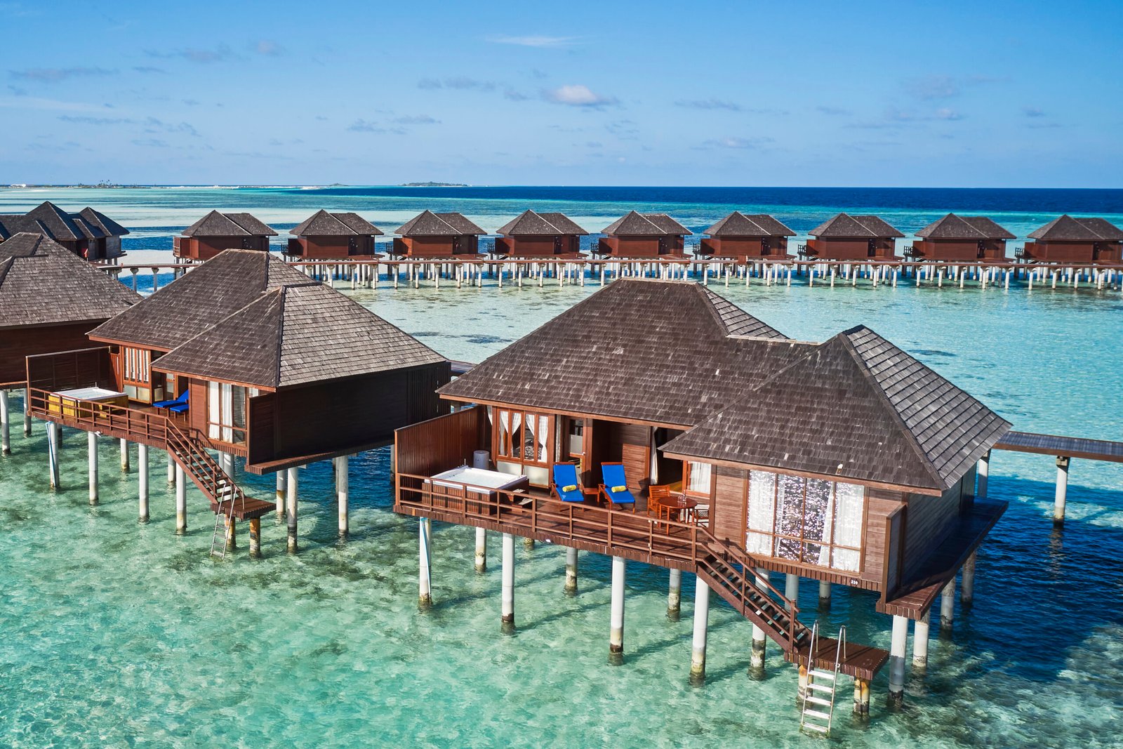Aerial view of overwater villas over the lagoon at Sun Siyam Olhuveli, Maldives