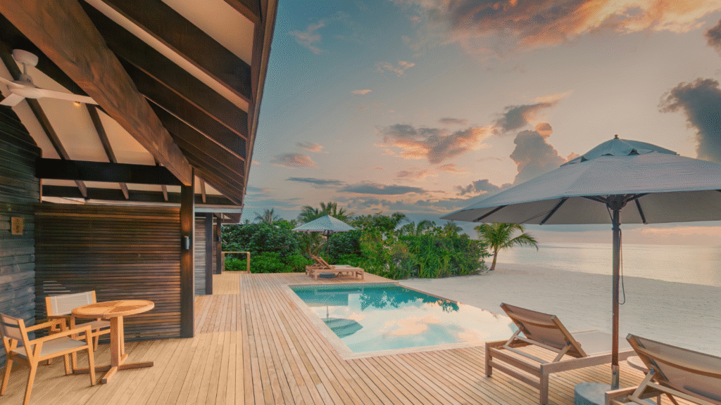Beach villa private pool deck at dusk, Jawakara Islands Maldives