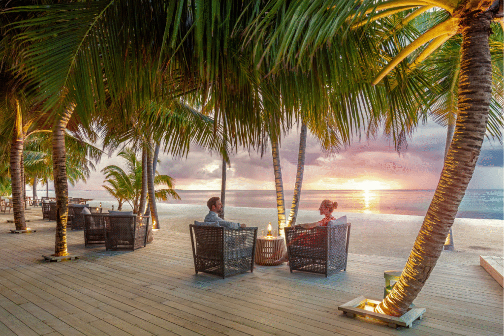 Beachfront dining lounge at sunset, Jawakara Islands Maldives