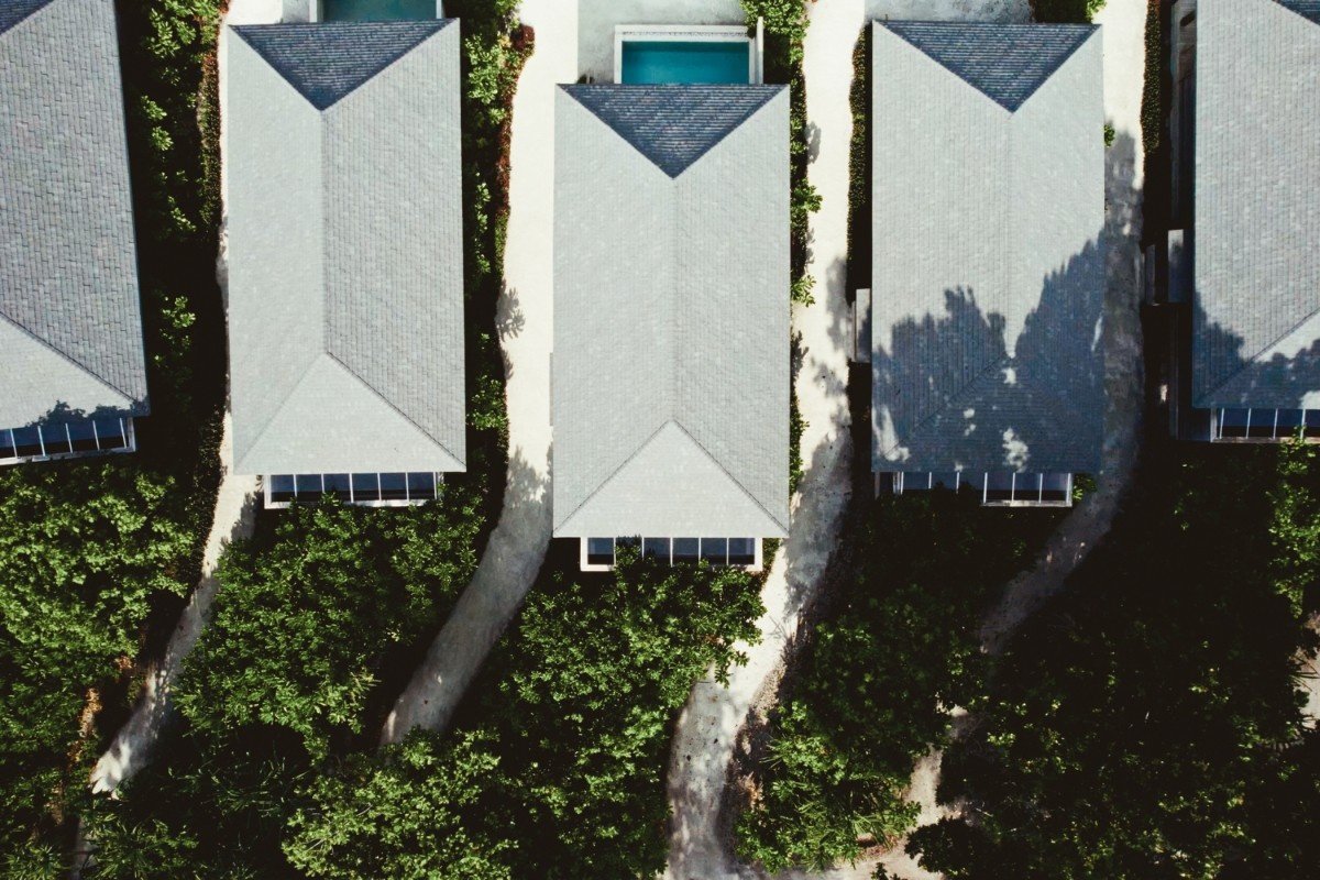 Aerial view of beach villa rooftops, Jawakara Islands Maldives