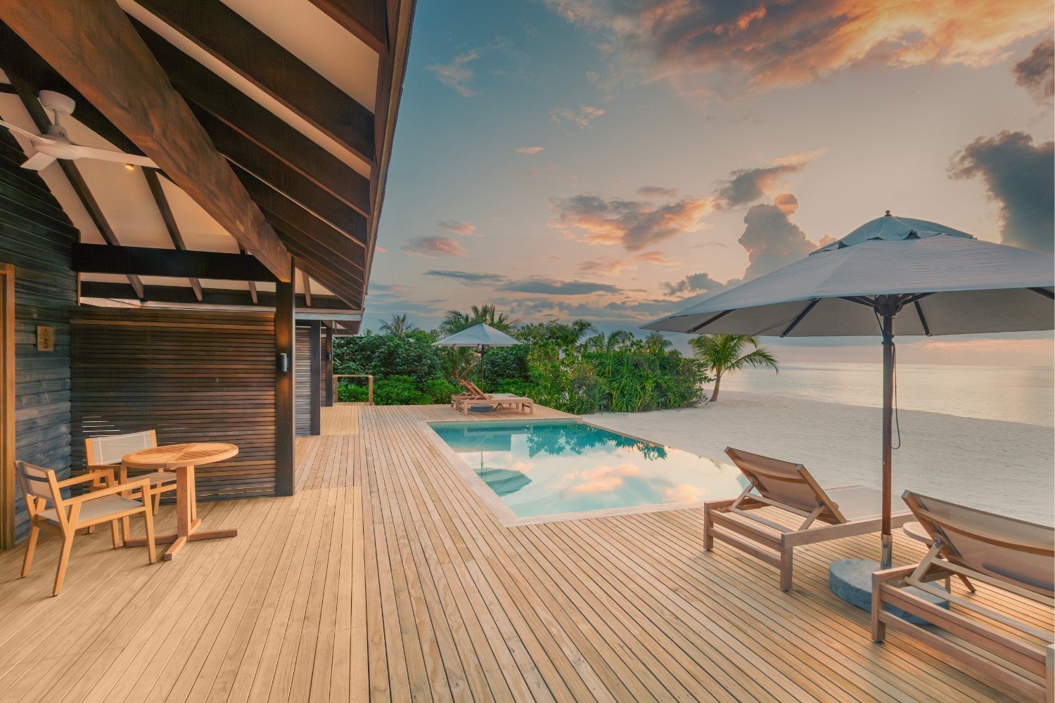 Beach villa private pool deck at sunset, Jawakara Islands Maldives