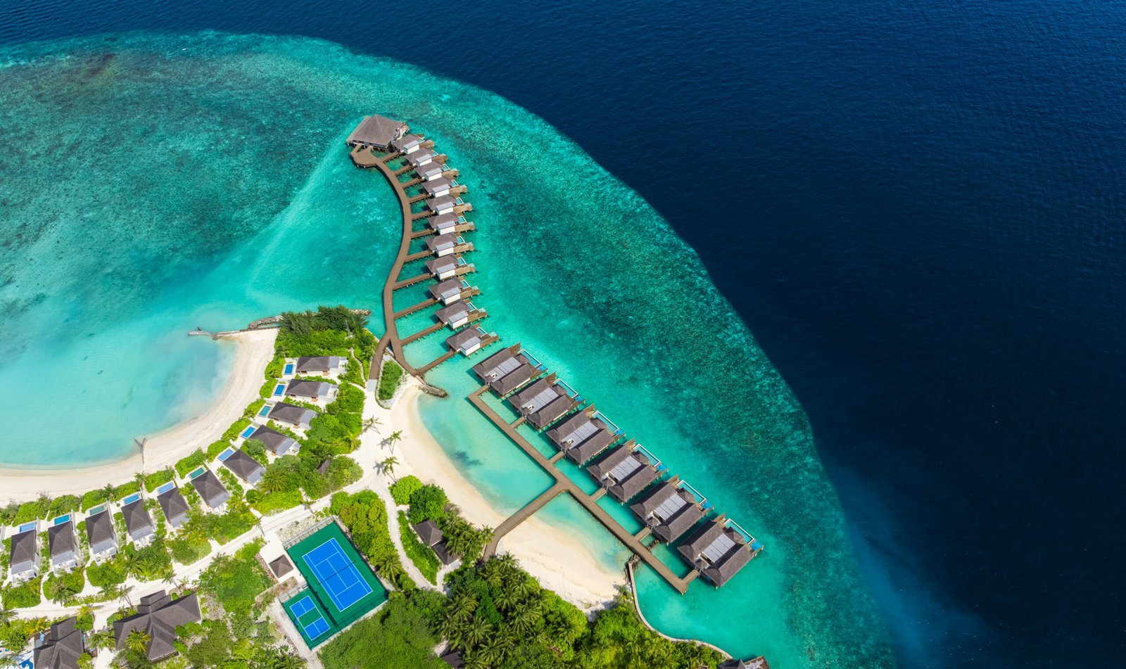 Turquoise lagoon and overwater villa walkway at dusitD2 Feydhoo Maldives, North Malé Atoll