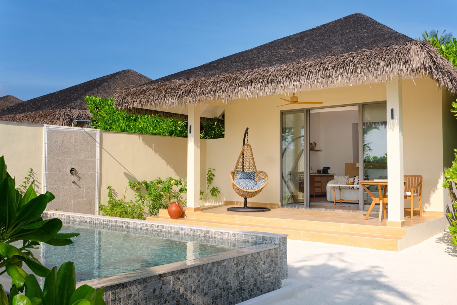 dusitd2-feydhoo-maldives-accommodation-beach-pool-villa-bedroom-exterior-pool-deck-area-pool-overview-scaled