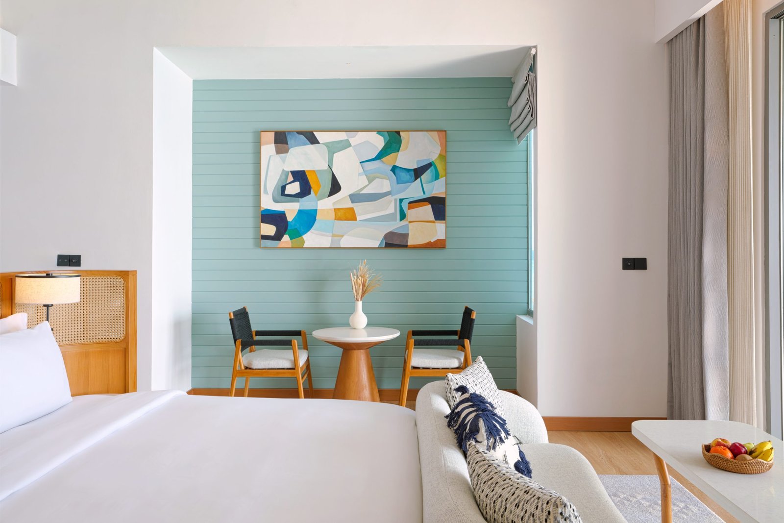 dusitd2-feydhoo-maldives-accommodation-overwater-pool-villa-bedroom-seating-area-scaled