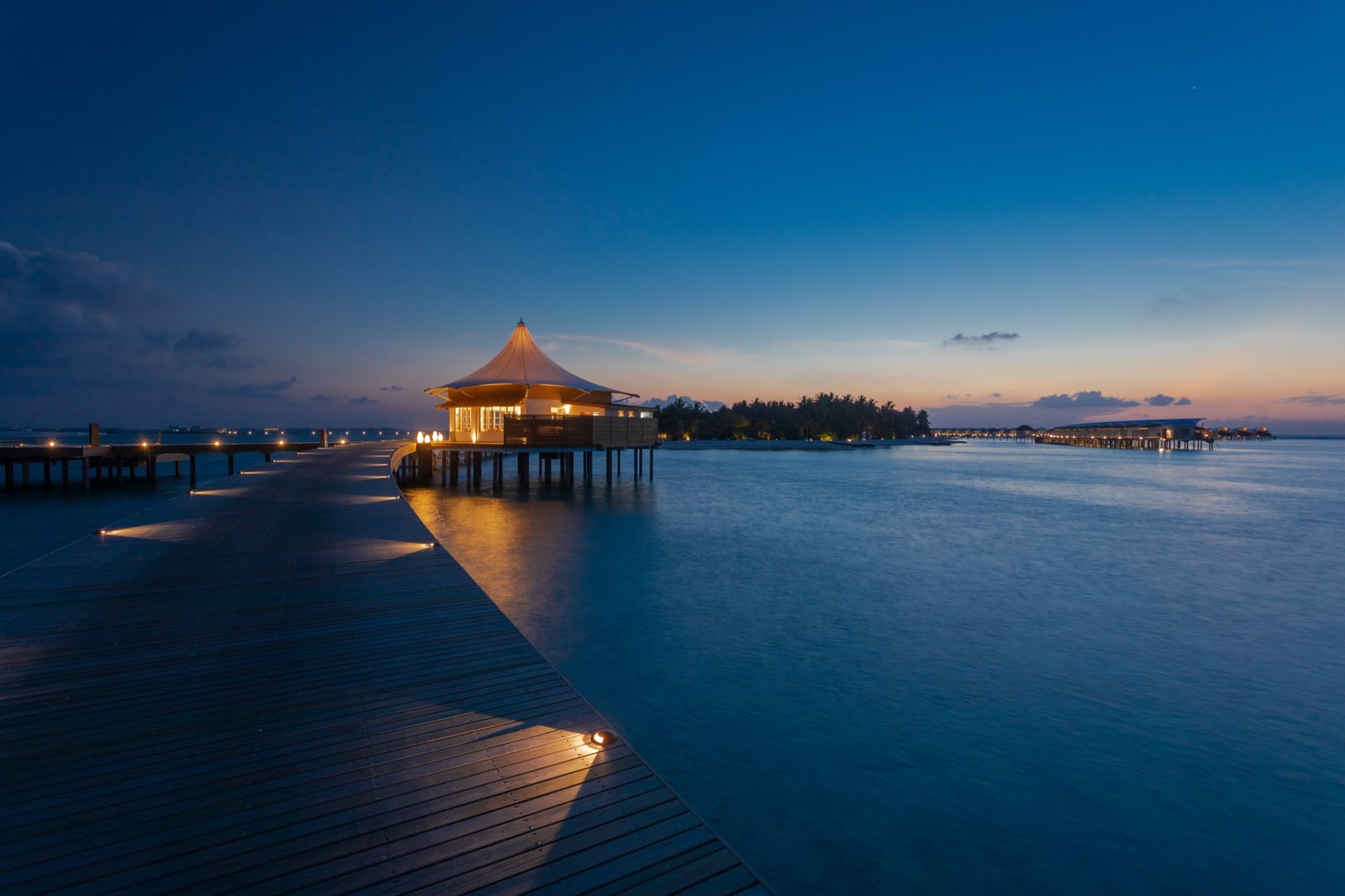 The Nalafalhu deck and arrival walkway at night, Cinnamon Hakuraa Huraa Maldives