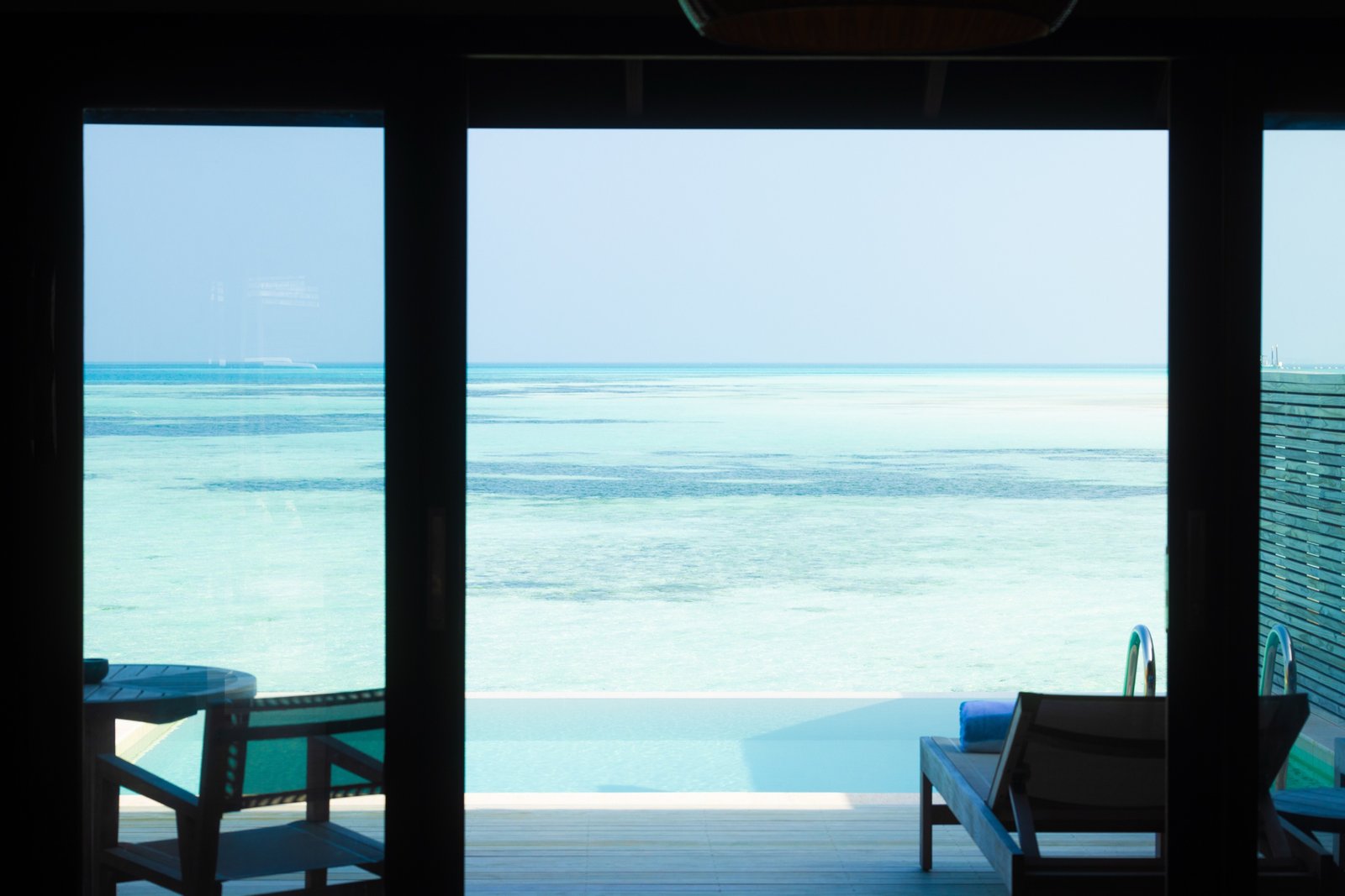 View over the private pool and lagoon from a Water Pool Villa, Jawakara Islands Maldives