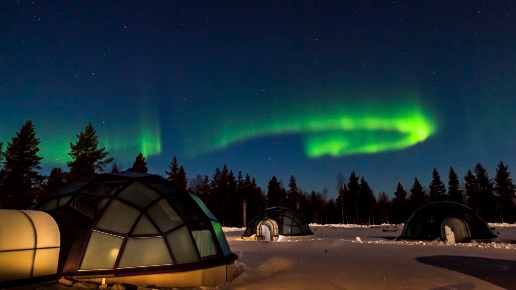 Glass igloos under the Northern Lights in deep snow, Kakslauttanen Arctic Resort, Saariselkä