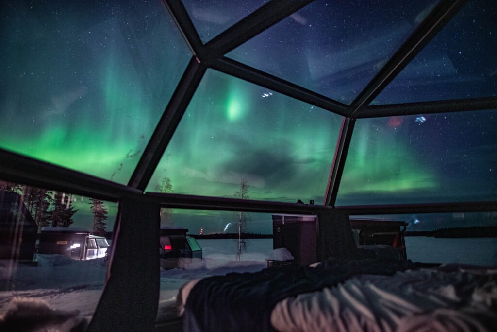 Northern lights over Lake Ranuanjärvi, viewed from inside a Glass Igloo, Ranua Resort