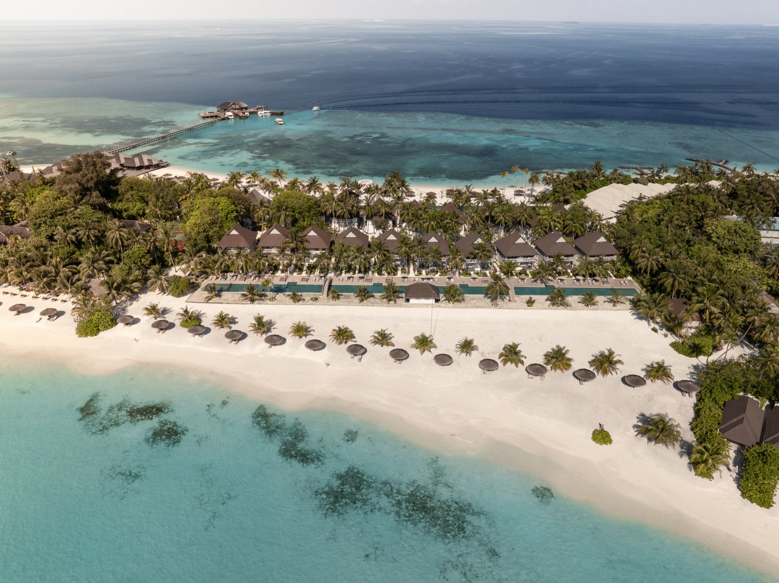 Aerial view along the Beach Pavilion pools, beach and lagoon, Sun Siyam Olhuveli