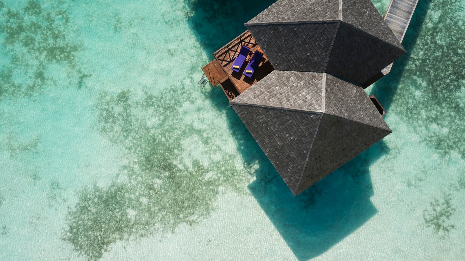 Water Villa roofs over the lagoon from the air, Sun Siyam Olhuveli