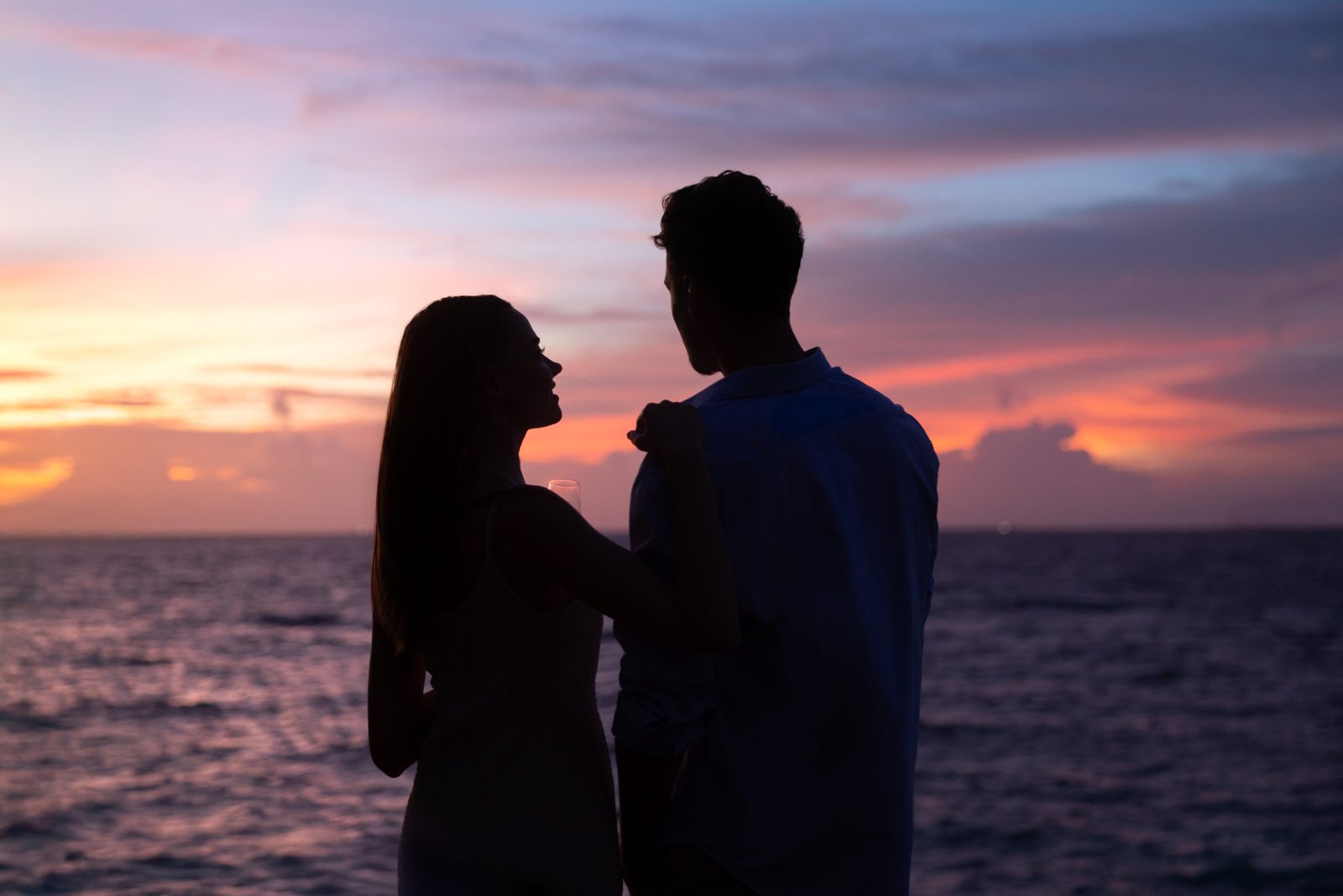 Couple watching the sunset at dusitD2 Feydhoo Maldives, Maldives