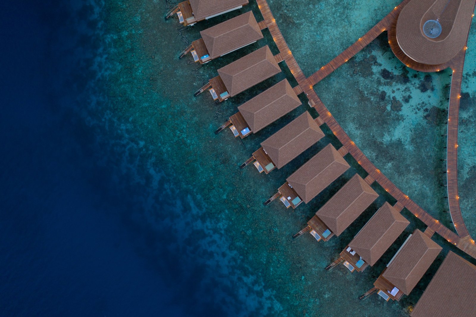 The water-bungalow arc over the reef at Cinnamon Velifushi Maldives, Vaavu Atoll