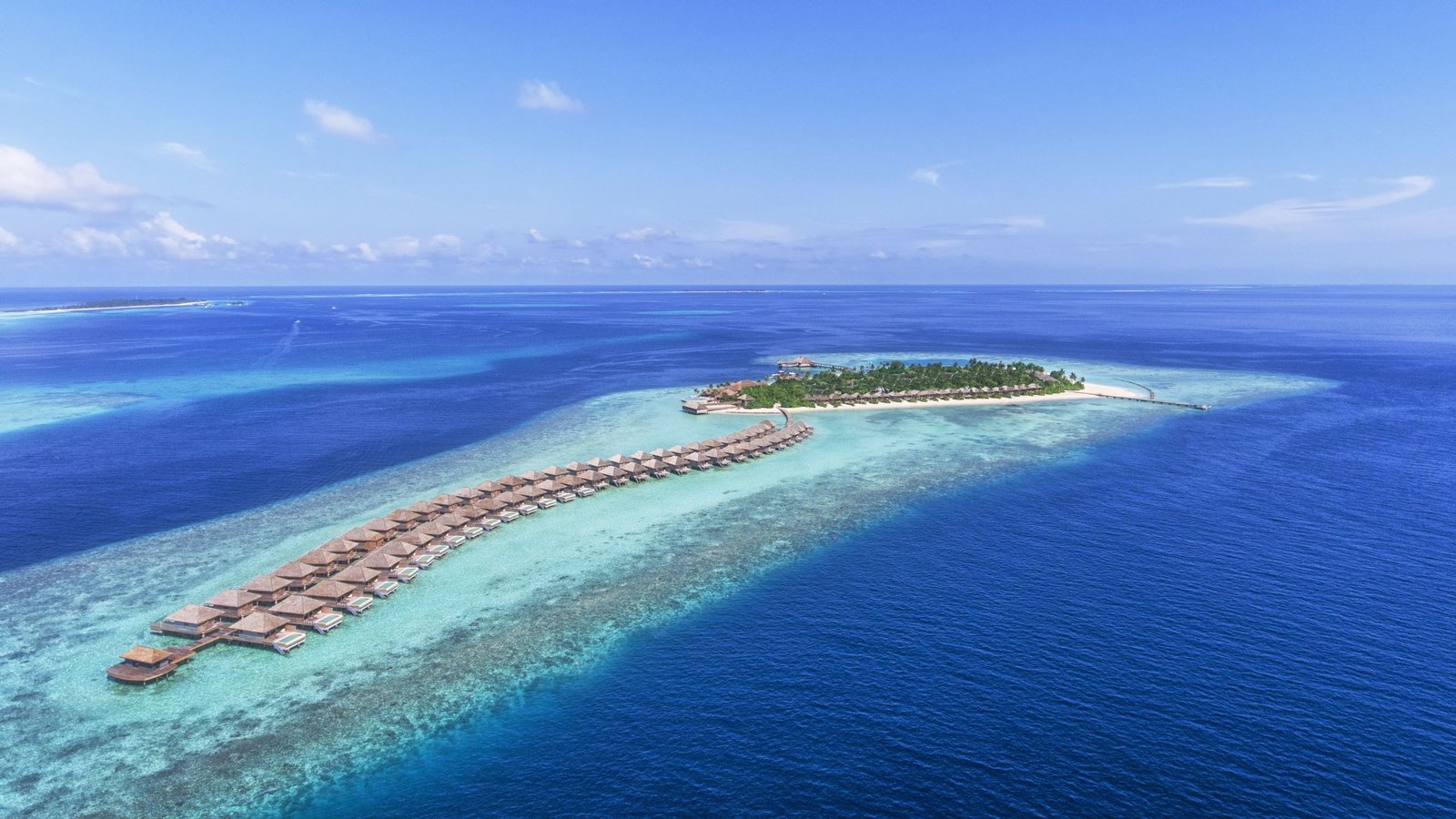 Hurawalhi Island Resort and its overwater villa row on the reef edge, Lhaviyani Atoll