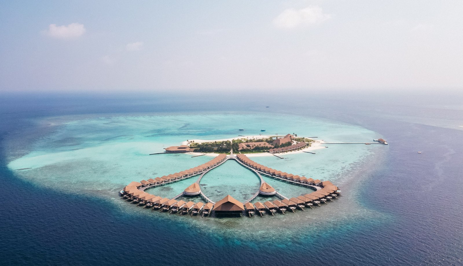 The island and water-bungalow arc at Cinnamon Velifushi Maldives, Vaavu Atoll