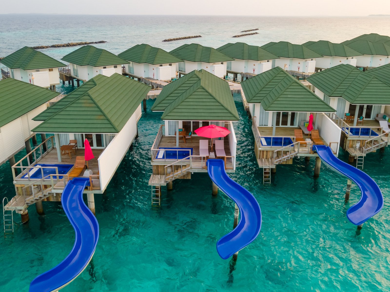Water villas with slides into the lagoon at Siyam World, Noonu Atoll