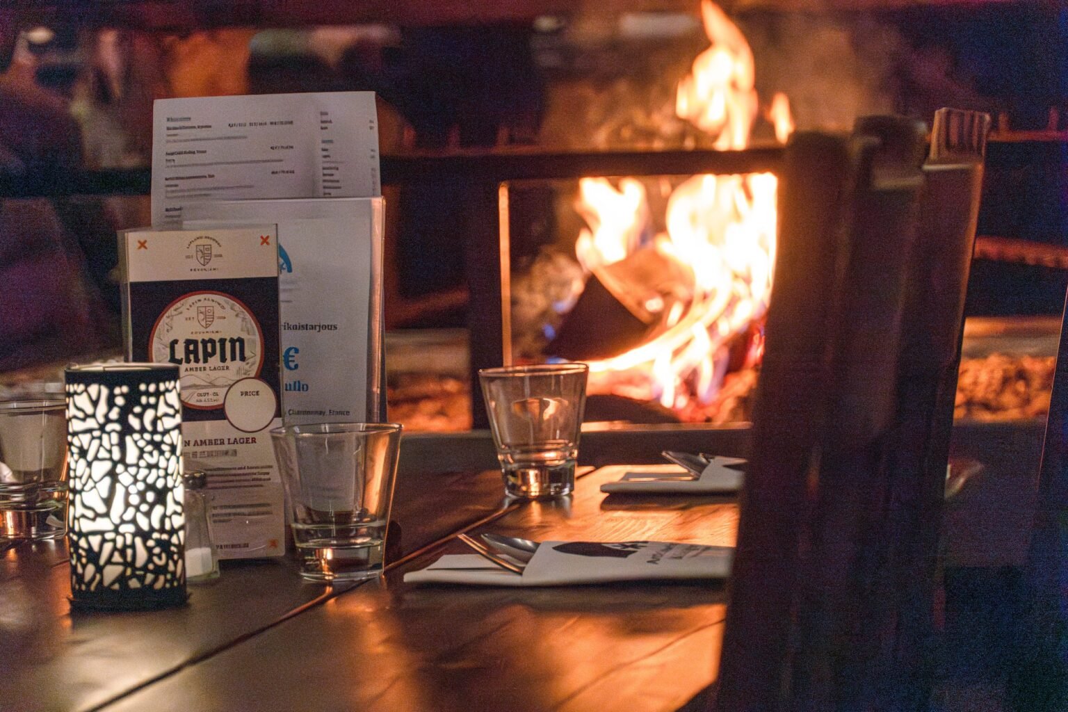 The Kota Restaurant, dining around an open fire — Arctic SnowHotel & Glass Igloos, Sinettä, Rovaniemi
