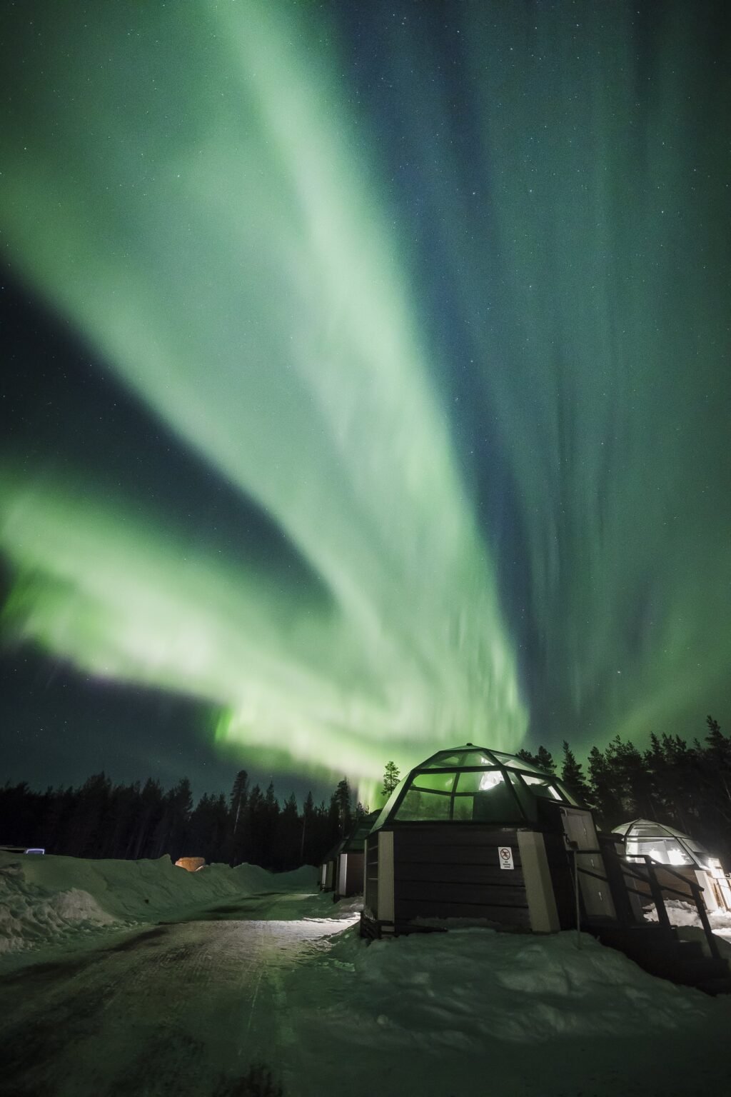 A heated glass igloo under the night sky — Arctic SnowHotel & Glass Igloos, Sinettä, Rovaniemi