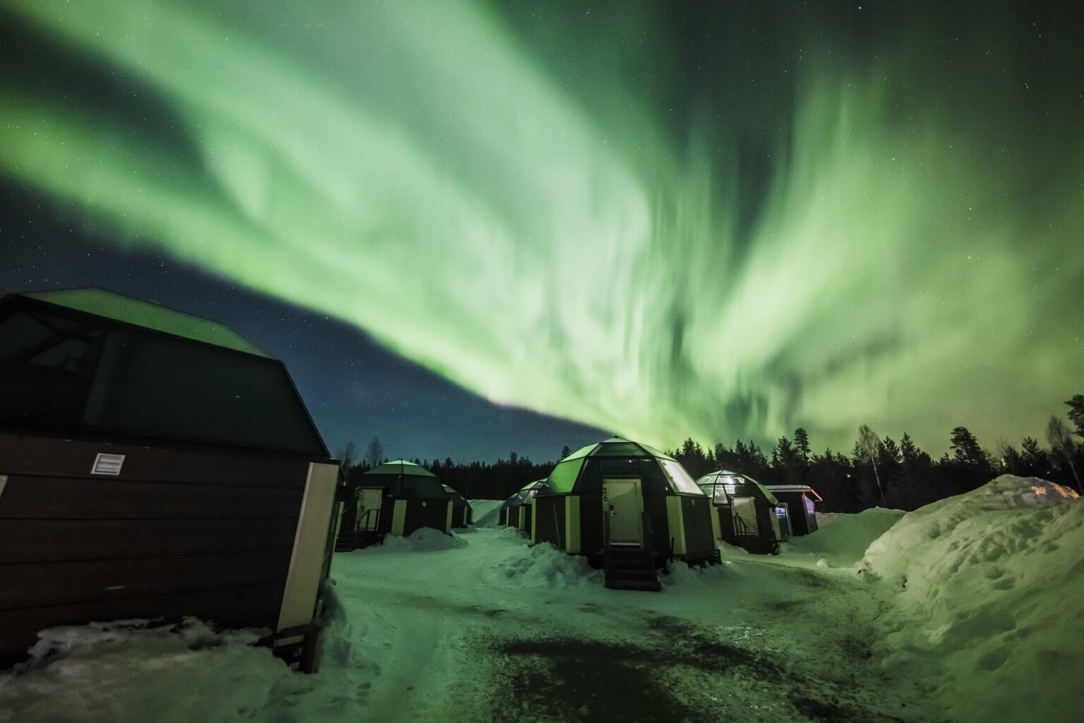 A heated glass igloo under the night sky — Arctic SnowHotel & Glass Igloos, Sinettä, Rovaniemi