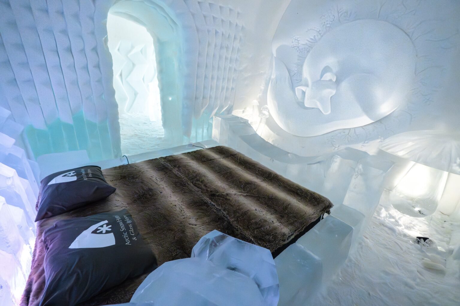 A room carved from snow, kept between 0 and −5 °C — Arctic SnowHotel & Glass Igloos, Sinettä, Rovaniemi