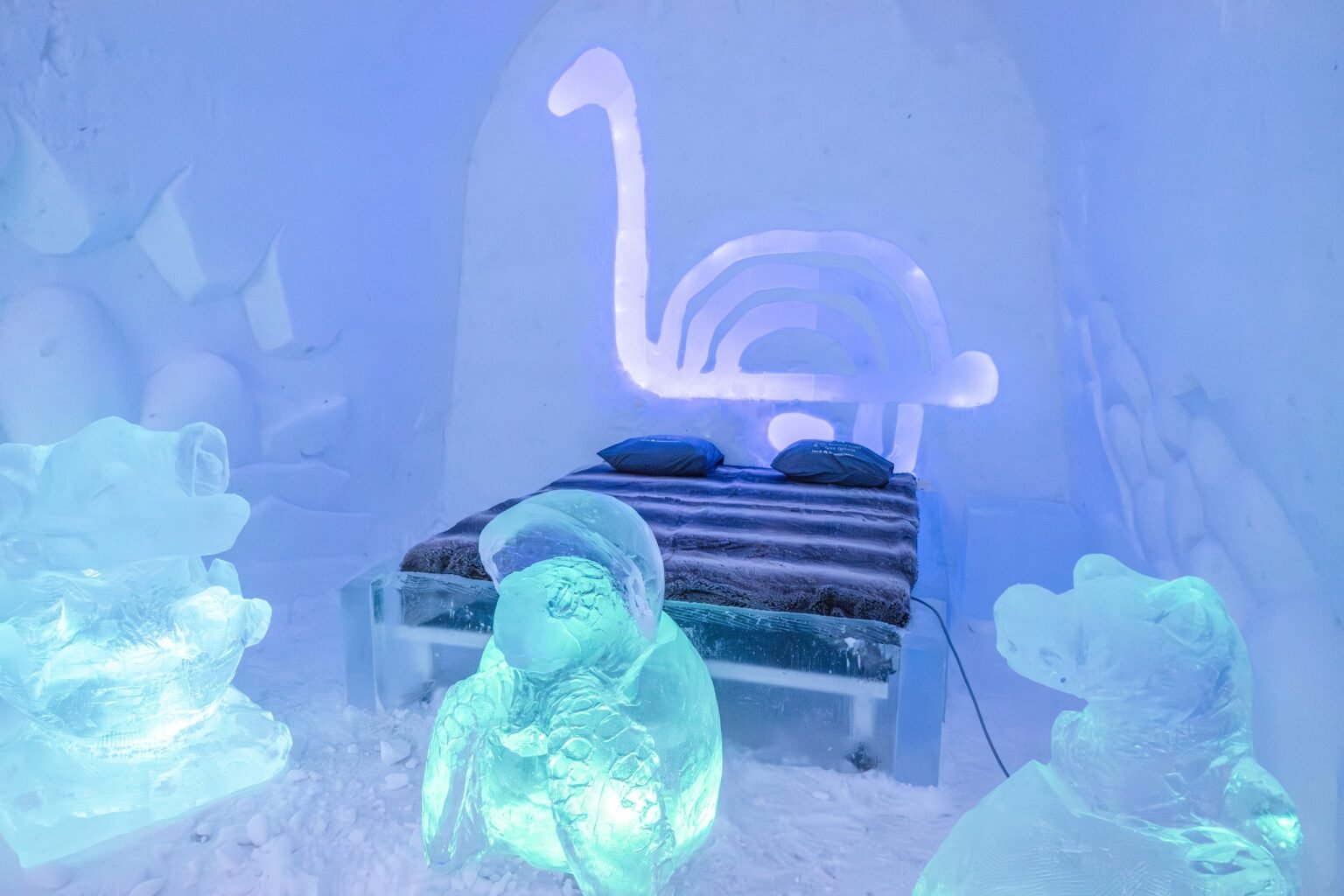 A room carved from snow, kept between 0 and −5 °C — Arctic SnowHotel & Glass Igloos, Sinettä, Rovaniemi