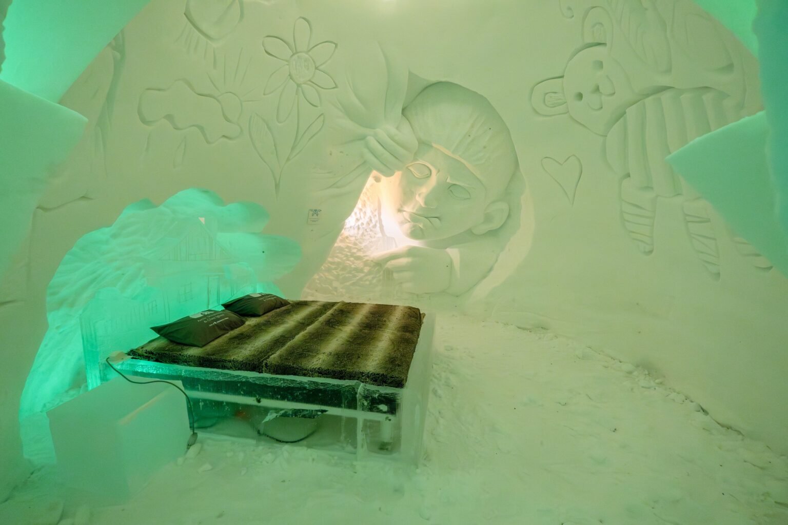 A room carved from snow, kept between 0 and −5 °C — Arctic SnowHotel & Glass Igloos, Sinettä, Rovaniemi