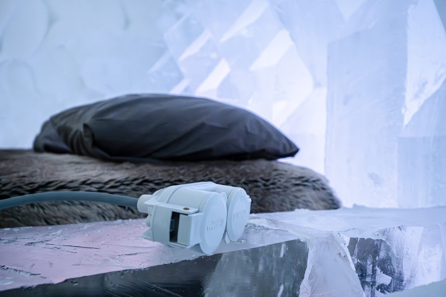 A room carved from snow, kept between 0 and −5 °C — Arctic SnowHotel & Glass Igloos, Sinettä, Rovaniemi