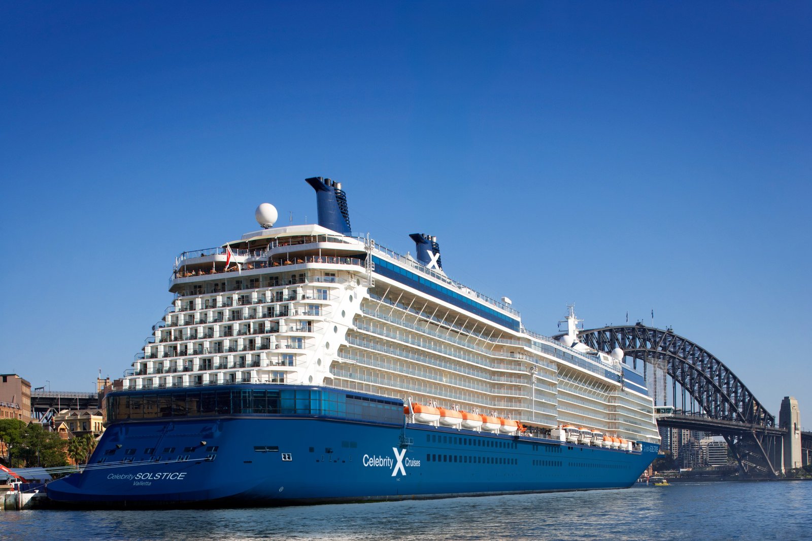 A Celebrity Cruises ship alongside the Sydney Harbour Bridge