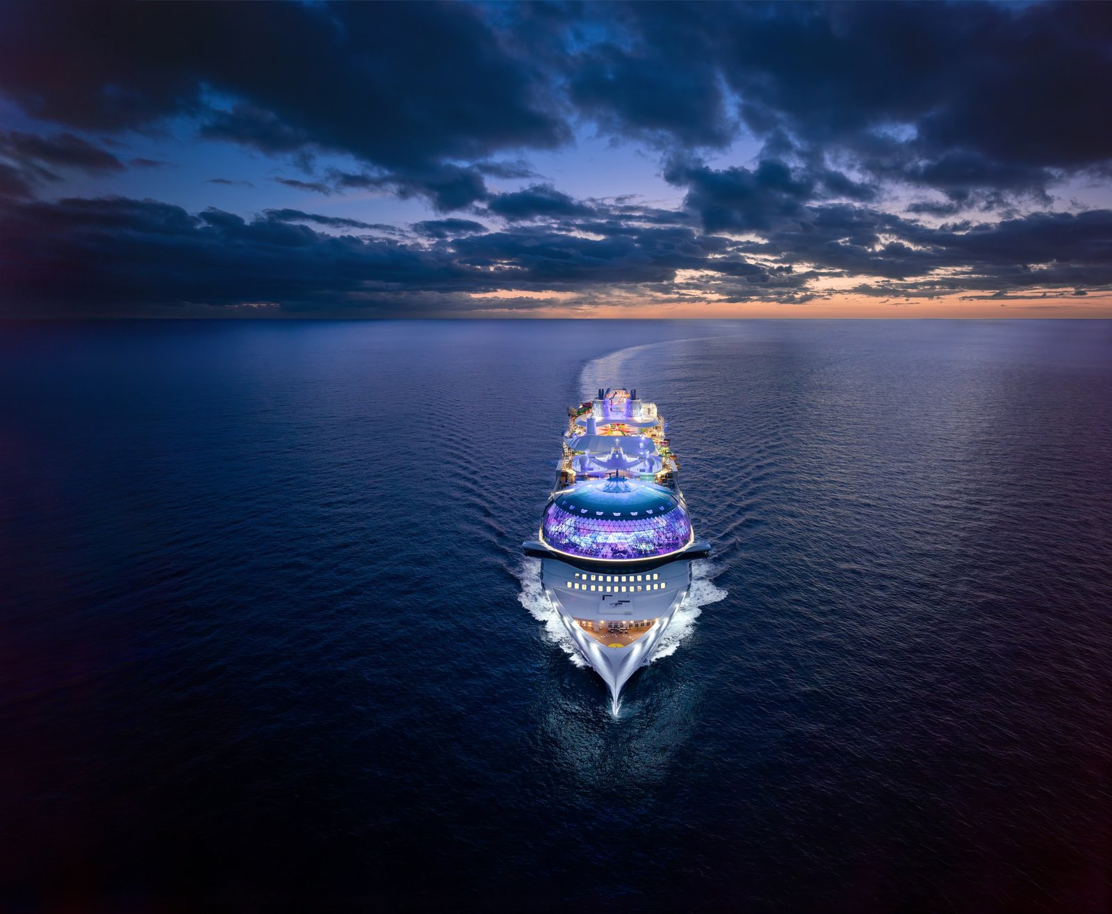 A Royal Caribbean ship at dusk on open water