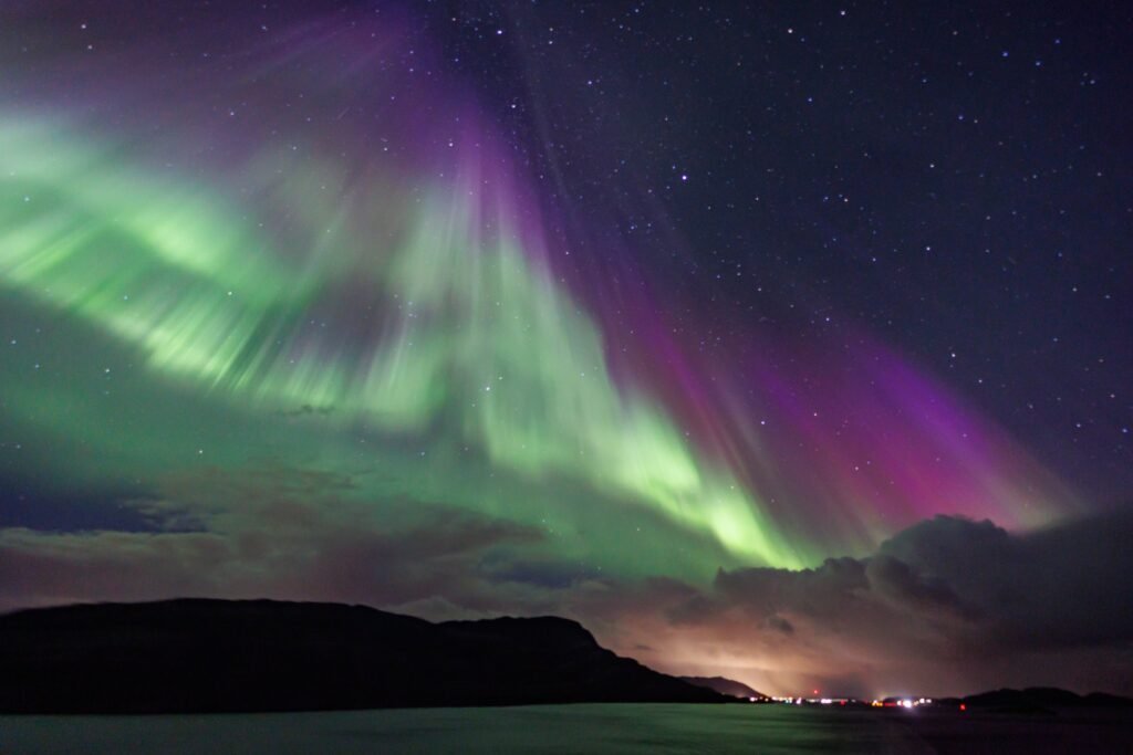 Green and violet aurora over the Norwegian coast