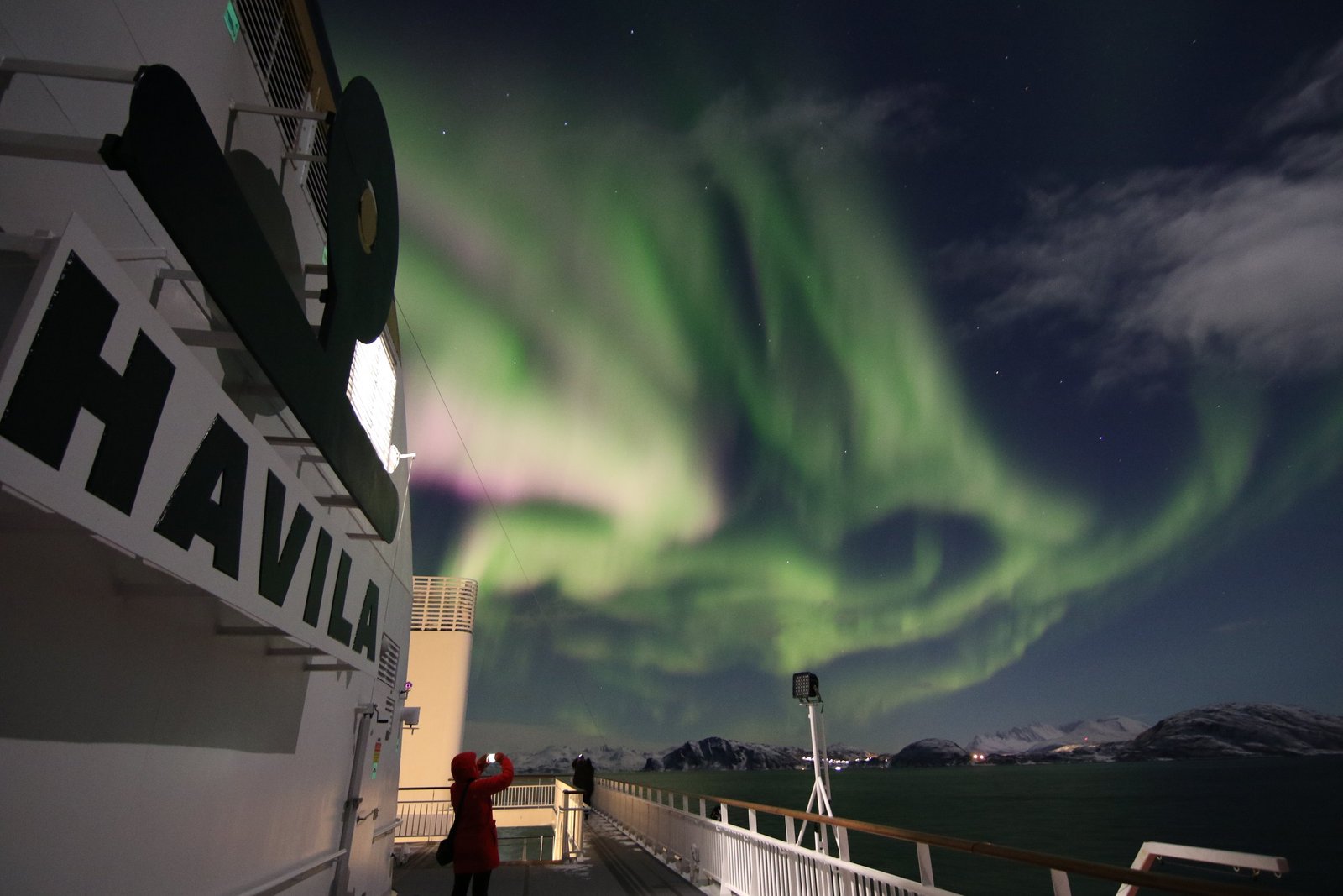 Northern lights above a Havila ship on the coastal route