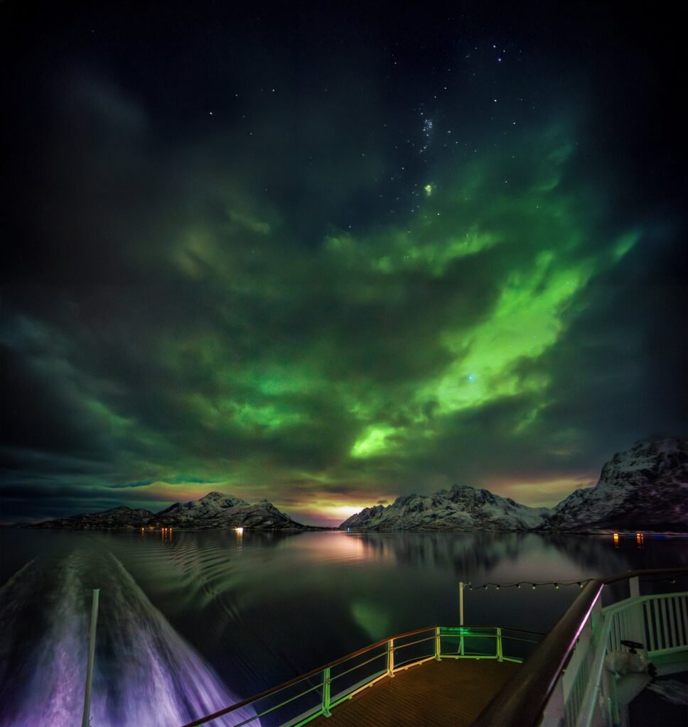 Aurora over the deck of a Havila ship at sea