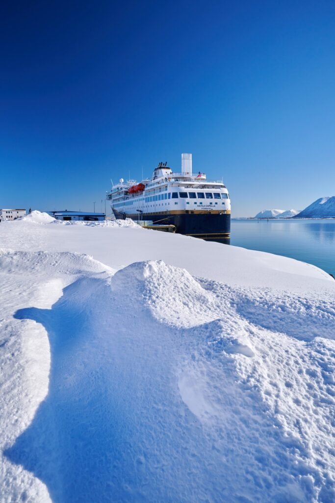Havila Capella alongside in winter, her name and home port of Fosnavåg on the stern
