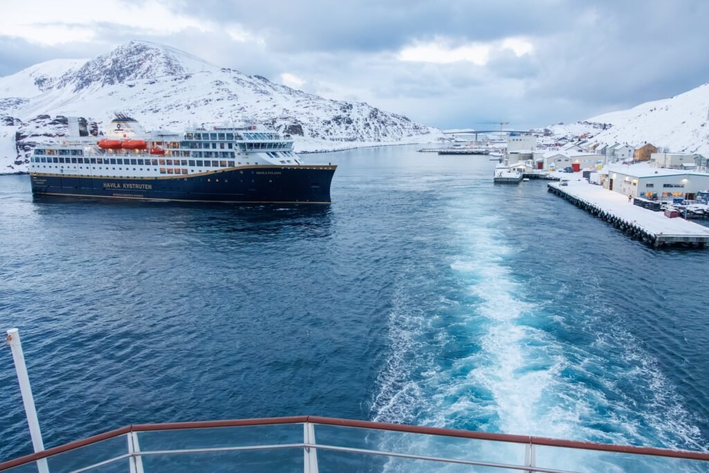 Havila Polaris leaving Havøysund, seen from the stern of another coastal ship