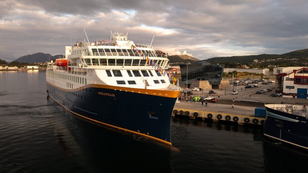 Havila Pollux alongside, her name lettered on the bow